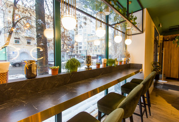 Cozy Interior of restaurant in morning lights with big window