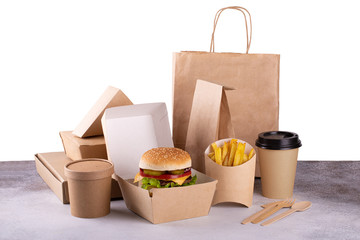 Delivery food eco packaging with burger and french fries, coffee isolated on white background. Fast...