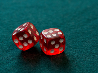 red dices on green cloth casino gambling luck