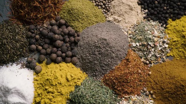various colored spices and seasonings rut in the frame top view 4k