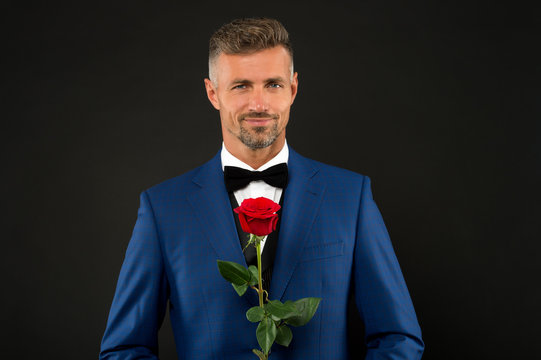 Lovely face of male. groom in tuxedo with rose. during wedding ceremony. groom in wedding jacket. bowtie is principal element for men. fashionable man with flower. groom man in suit. elegant boy