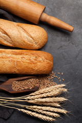 Various bread with wheat and cooking utensils