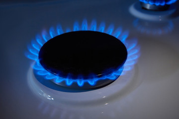 gas burner in the dark with blue flame close-up
