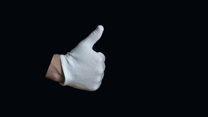 White-gloved hand on a black background. hand in white glove showing sign - thumb up, on black background, sign language
