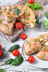 Burek with cheese and spinach filling. Traditional Balkan cuisine pie on the white wooden table