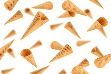 Falling Empty ice cream cone, isolated on white background, selective focus