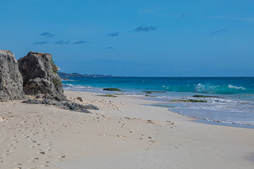 Looking along the idyllic Elbow Beach on the island of Bermuda, with a blue sky overhead