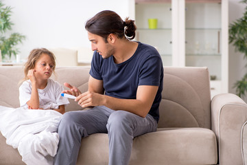 Obraz premium Father taking care of his ill daughter