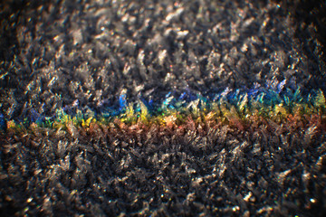 Colors of the rainbow on a morning frosted surface of fractal cristals, the spectrum of the light...