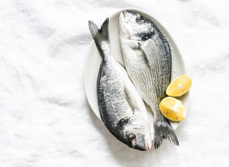 Fresh raw organic dorado on light background, top view. Food ingredients
