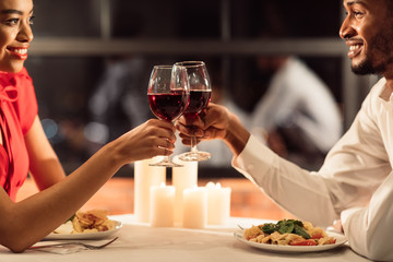 Loving Couple Toasting Clinking Glasses Celebrating Valentine In Restaurant, Cropped