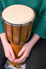 Fototapeta na wymiar Hands of a girl on a drum