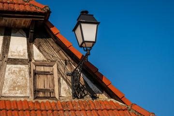 Fototapeta na wymiar A lantern on the roof of a half-timbered house