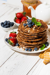 stack of homemade delicious pancakes for breakfast, vertical top view