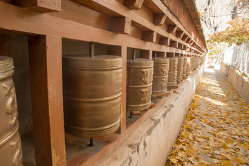 buddhist prayer wheels in himalayan temple