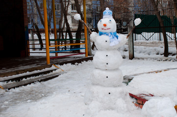 snowman in winter in a scarf