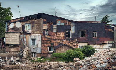 Fototapeta premium Facade of old residential half demolished building