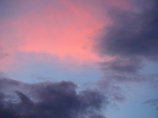 Fototapeta na wymiar Dark gray and red clouds on a blue sky background