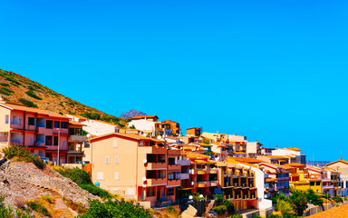 Obraz premium Cityscape with Buggerru city with cottage house architecture at the Mediterranean Sea in South Sardinia in Italy. Sardinian Italian small town in Sardegna.