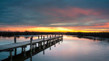 Fototapeta na wymiar Jetty on lake neusiedlersee in Burgenland at sunrise