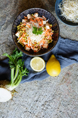 Easy vegan salad with boiled green peas, fresh parsley root slices and carrot, smoked tofu and topped with Alfalfa sprouts