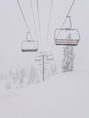 Chairlifts in the morning at a ski resort in heavy snow