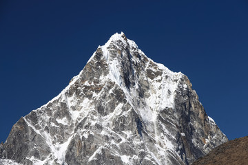 Cholatse mountain peak in Himalayas in sunny day. It's a mountain in the Khumbu region of the...