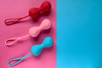 Sex toys for woman. Jiggle balls on a color background. Three ben wa balls of silicone. Useful for sex shop