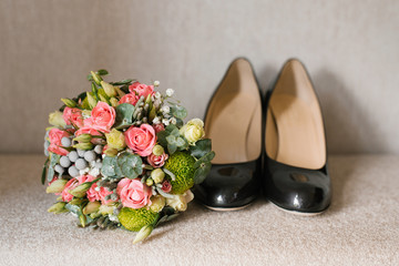Accessories for the bride on the wedding day: shoes, a beautiful bouquet