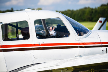 White light aircraft with one propeller and four seats at air show in western Germany. A plane...