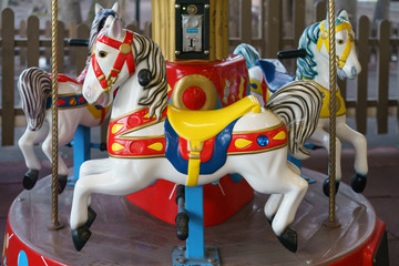 Riding around a horses carousel in winter day. Chrismas Eve and New Year mood. Amusement park for...