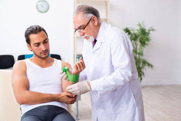 Fototapeta premium Young male patient visiting experienced doctor