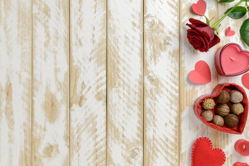 Valentines day romantic decoration with roses and chocolate on a white wooden table. Top view, copy space.