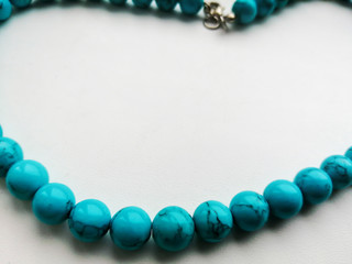 two strands of white pearls on a light background