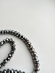 hematite necklace thread on white background