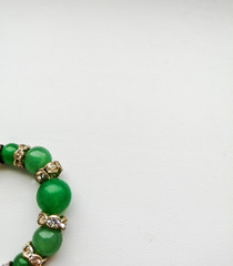 green stone beads, decoration on a white background