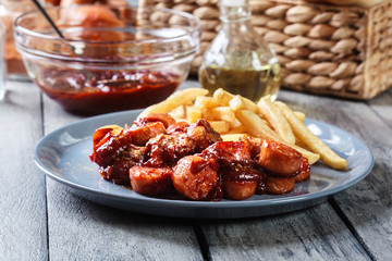 Traditional German currywurst - pieces of sausage with curry sauce