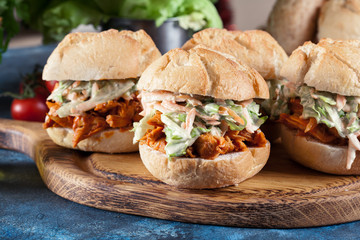 Pulled chicken sandwich with salad and bbq sauce