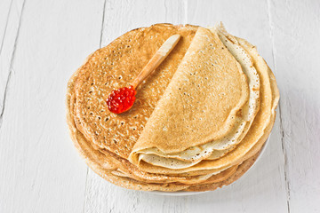Stack of russian pancakes (crepes) with red caviar. Traditional Maslenitsa (Shrovetide) meal.