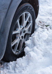 Tire on snow. Car staying on snowy road. Staying on the iced road. 