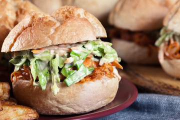 Pulled chicken sandwich with salad and bbq sauce