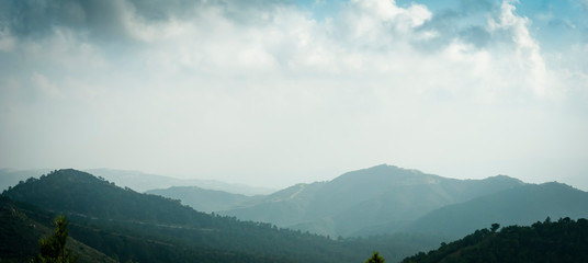 Cyprus mountain landscape panorama, aerial view in fog, mist or low lying clouds in sunlight. Beautiful mediterranean nature.
