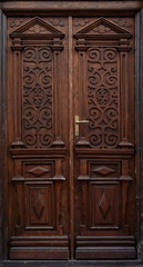 antique brown wooden door decorated with wooden carvings