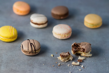 Assorted macaroon cakes on a gray background.