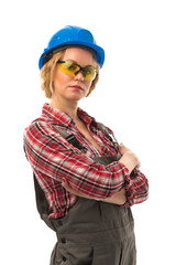 Attractive european female engineer in coveralls, safety blue helmet and safety glasses isolated on white background