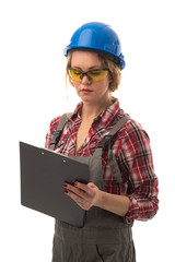 Attractive european female inspection engineer in coveralls, safety blue helmet, safety glasses and paper tablet isolated on white background