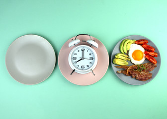 Intermittent fasting concept with empty colorful plates. Time to lose weight , eating control or...