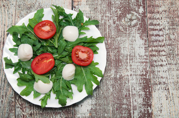 Fresh salad with tomatoes, rucola and cucumbers