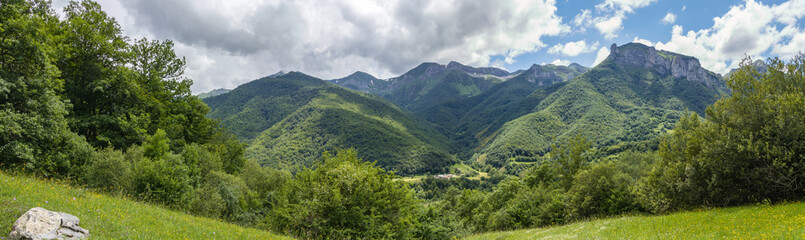 Green mountains and cloudy sky