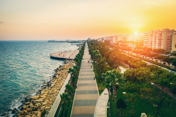 Obraz premium Molos Promenade on Limassol City coast in Cyprus at Sunset, Aerial View from Drone.